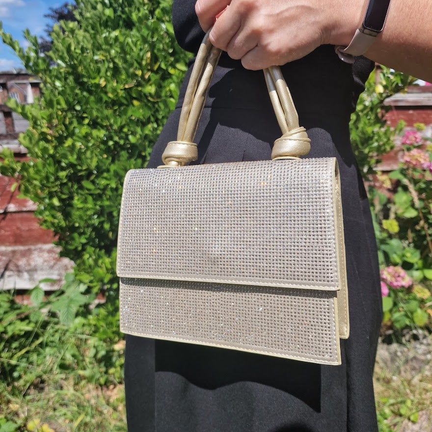 diamante knot handle gold clutch bag